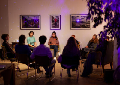 Group seated in a circle during a facilitated community discussion