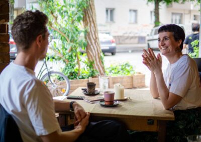 Judit Saez in conversation with a client at a cafe table